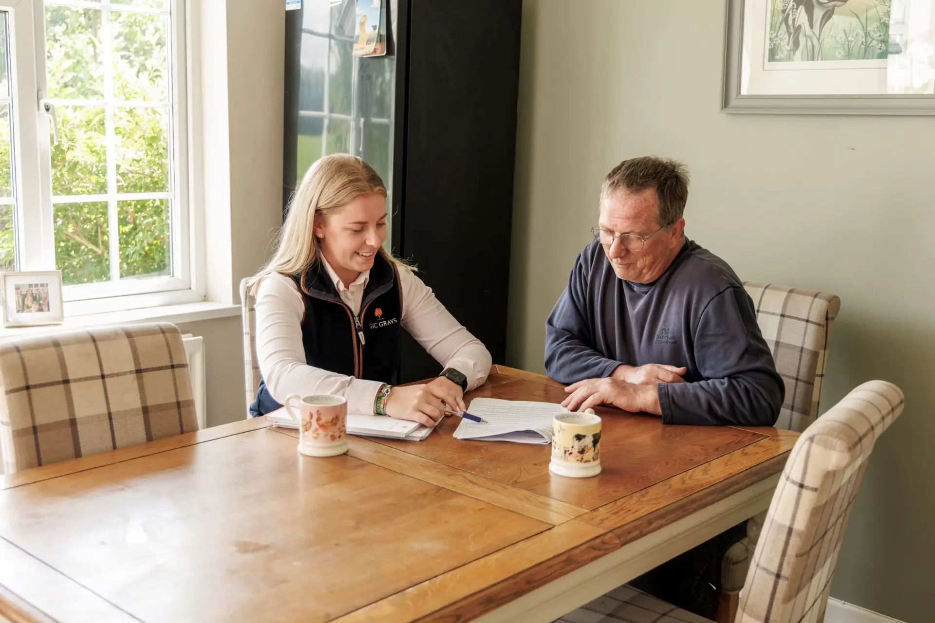 Farm consultant and client discussing at kitchen table