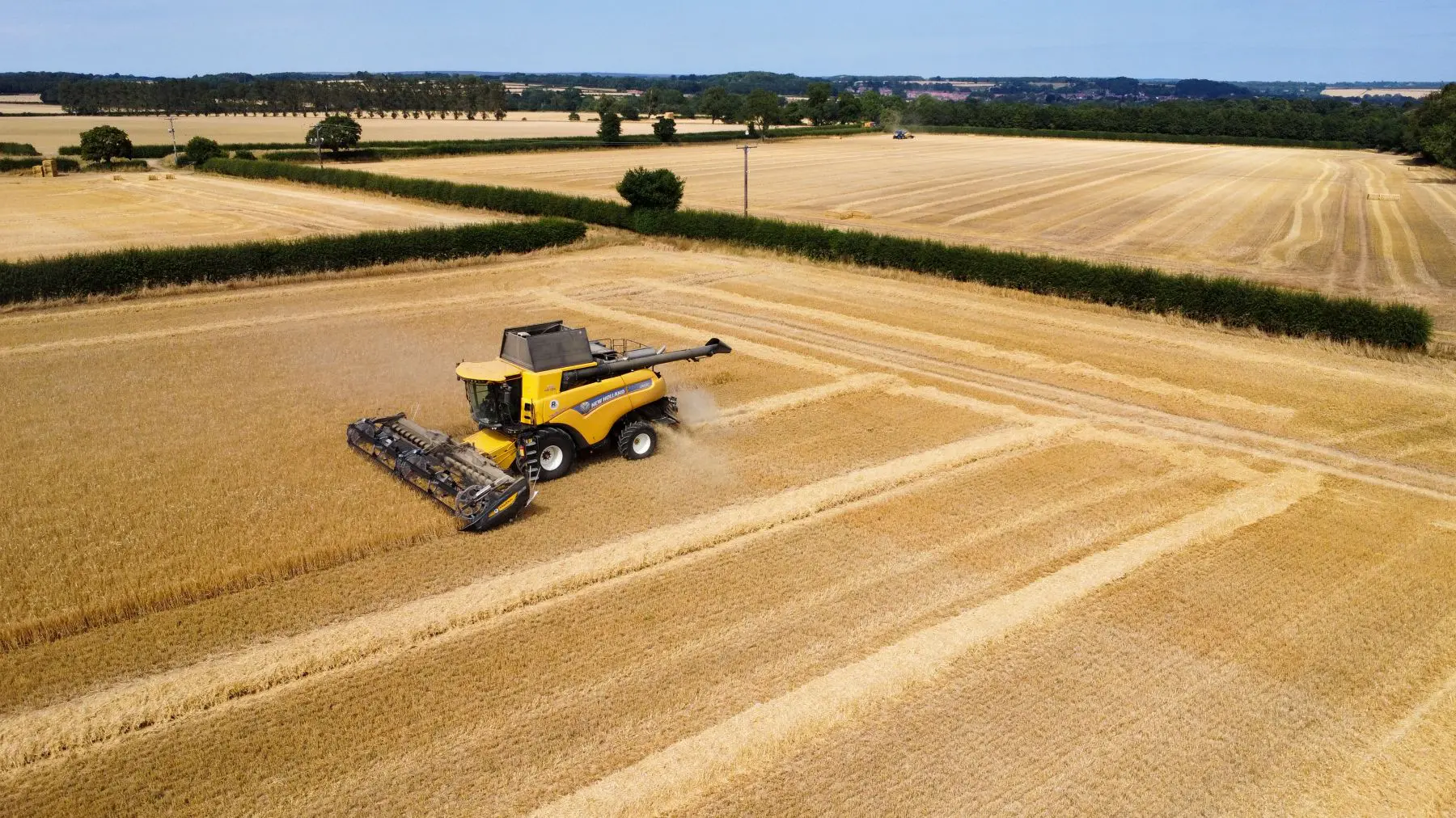 Combine harvester in arable field