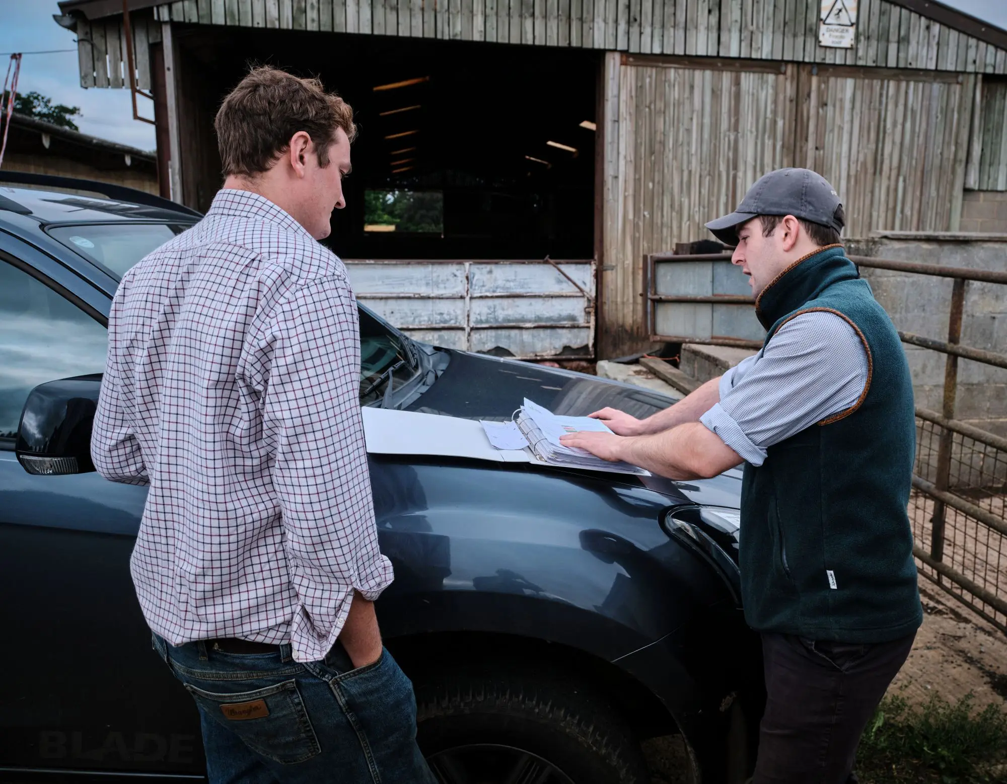 Agronomist talking with client over farm map